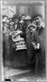 A woman distributes suffrage broadsides, January 1911.