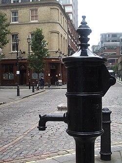 A pump memorializing John Snow for his study of contaminated water as a likely source of cholera during the 1854 Broad Street Cholera outbreak John Snow memorial and pub.jpg