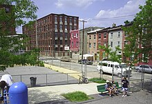 A playground in East Kensington and Beatty's Mills Factory Building in the background in 2006 Kensington.jpg