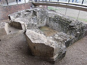 Photograph of excavated ruins in a sunken area.