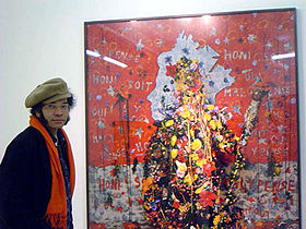 Locke beside his artwork "Saturn" from his series of photographs How Do You Want Me? (portrait by Pam Winfield, 2008) Portrait of Hew Locke by Pam Winfield - 2008.jpg