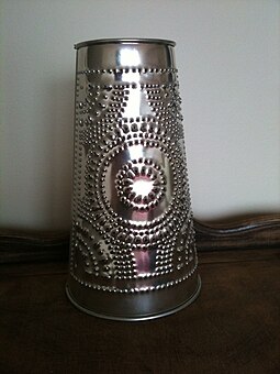 A 21st-century reproduction barn lantern made of punched tin. Punched tin barn lantern.jpeg