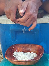 Coconut being grated