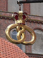 In Denmark, the official kringle emblem of the baker's guild is topped with a royal crown. Here from a modern bakery shop in Ribe.