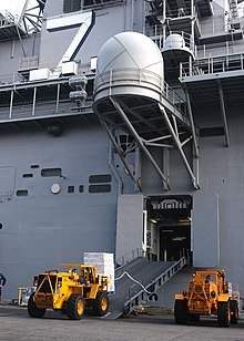 Lift trucks provisioning a navy ship US Navy 050831-N-3725R-004 Fork trucks from the amphibious assault ship USS Iwo Jima (LHD 7) load stores from the pier to the ship prior to getting underway from Naval Station Norfolk.jpg