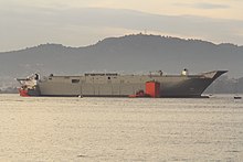 Adelaide being loaded onto the heavy lift ship Blue Marlin at Vigo Bay, prior to being transported to Williamstown for completion Vigo Embarque del portaaviones HMAS Adelaide en la plataforma Blue Marlin (11311950946).jpg