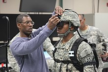 A U.S. soldier being prepared to use a ground combat training virtual reality headset at Fort Stewart in 2013 Virtual reality training 130416-A-BZ540-008.jpg