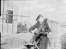 Wren N S Hopkins, from London, operating a Holman projector, on the Defensively Equipped Merchant Ship ranges at Cardiff. Wren and Holman Projector 1943 IWM A 20405.jpg