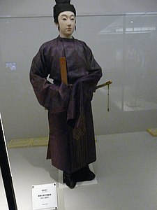 Men's dress, with kanmuri hat, hakama, ornate sash, shaku and sword.