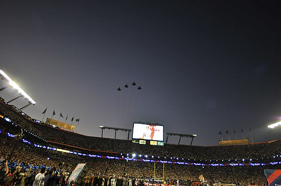 Aircraft of the 125th Fighter Wing perform a flyover while Carrie Underwood sings the National Anthem.
