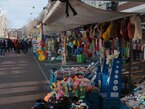 2023 Amsterdam - a market stall at the Albert Cuyp market, with a lot of household stuff and articles for sale in the sunlight; it is still rather quite at the market - free download photo in Dutch street photography by Fons Heijnsbroek, Netherlands