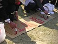 A Japanese is writing "不要WTO"(no WTO)