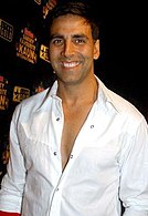 A smiling Akshay Kumar in a white shirt