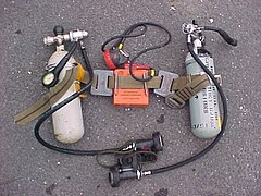The original belt style British sidemount harness, with cylinders, weights and battery canister mounted.