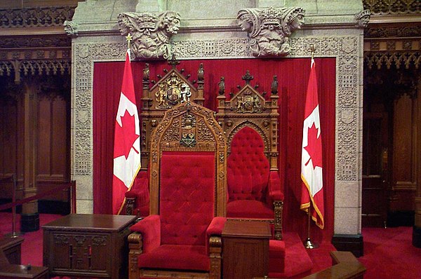 The Speaker of the Senate occupies the chair in front of the thrones.