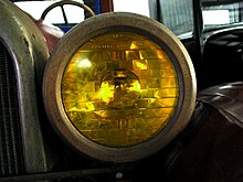 One of the first optical headlamp lenses, the Corning Conaphore. Selective yellow "Noviol" glass version shown. Corning Conaphore y.jpg