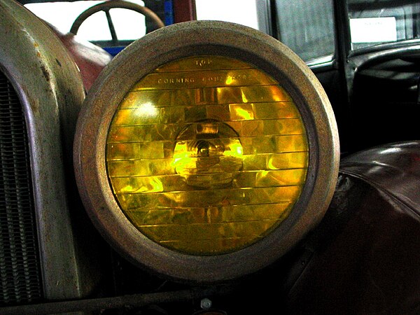 One of the first optic headlamp lenses, the Corning Conaphore. Selective yellow "Noviol" glass version shown.