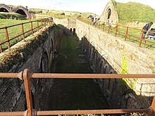 Inside the Redoubt: soldiers' barracks (top left), guardroom (below left), officers' quarters (below right), small arms store (top right) Dover - 2014 (geograph 4222649).jpg