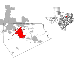 An image of the shape of the state of Texas with lines differentiating the various counties in that state. One of the specific counties is filled in red. A larger image of that specific county sits next to the shape of Texas, with another red shape inside it to demonstrate a specific town within that county.