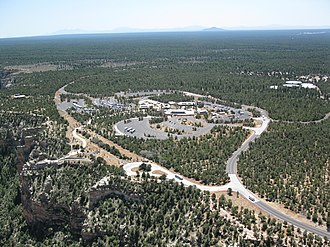 Grand Canyon Visitor Center on the South Rim of the Grand Canyon, and the Coconino Plateau beyond - in Grand Canyon National Park, Arizona. Grand Canyon- Improved Mather Point - Aerial 021 (5971962807).jpg