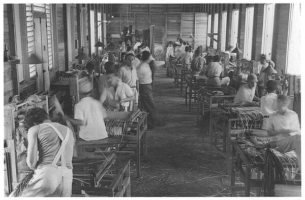 Jewish refugees in Sosúa, Dominican Republic work in a straw factory making handbags for export to the United States.