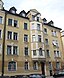 Konradstraße 5; Mietshaus, viergeschossiger Neurenaissancebau mit durch Erker und Zwerchhaus akzentuierter Mittelachse, Putzgliederung und Stuckdekor,...