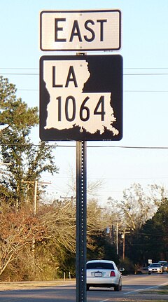 In 2009, Natalbany was among the first communities in Louisiana to get Louisiana's new black-and-white state highway shields. Shown here: LA 1064 from Natalbany center, looking east. Louisiana new state highway shield 1064 east Natalbany.JPG