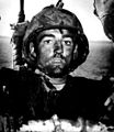 Back to a Coast Guard assault transport comes this Marine after two days and nights of Hell on the beach of Eniwetok in the Marshall Islands. His face is grimey with coral dust but the light of battle stays in his eyes. February 1944