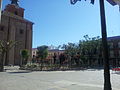 Esquina nor-oeste de la Iglesia de la Inmaculada Concepción y vista parcial de la plaza de España o plaza Mayor de Herencia