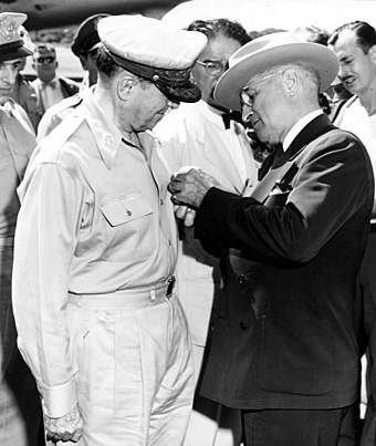 President Harry S. Truman awards the Distinguished Service Medal, Fourth Oak Leaf Cluster, to General Douglas MacArthur during the Wake Island Conference.