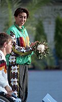 Triple gold medalist Priya Cooper standing on the gold medal podium Priya Cooper on 1992 Paralympics medal podium.jpg