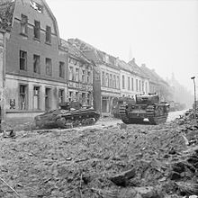 A Valentine Mk XI Royal Artillery OP tank (left) and a Churchill tank (right) in Goch, 21 February 1945 The British Army in North-west Europe 1944-45 B14779.jpg