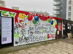 "All we want for Christmas is the Happy Man Tree" mural