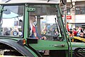 File:Tractor driver pulling a Waggis during Cotrège.jpg