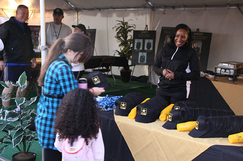 File:US Army 53084 Sgt. 1st Class Teresa Bozeman, right, distributes "Hooah" items, such as Army hats and tumblers, to visitors throughout the morning during the Army 10-Miler Oct. 4 in Washington, D.C.jpg