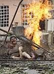 An injured woman sitting in rubble following a Russian bombing attack on Gori