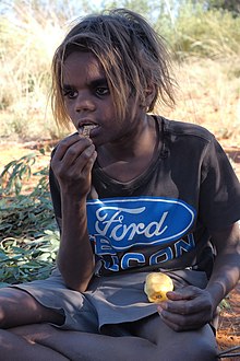 Aboriginal boy eating witchetty grub: Yuendumu, 2017 Yuendumu Gold 08.jpg