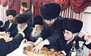 Grand Rabbi Avraham Yissachor Englard of Radzin with his eldest grandson Rabbi Nosson Nochum Englard of Radzin-Yerushalayim (seated right) rAdzyn.jpg