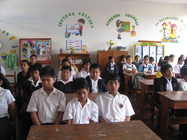 Students in Peru classroom practicing the TM technique