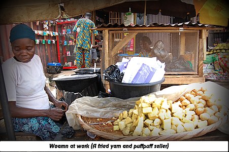 A woman selling fried yam and puffpuff