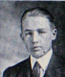 A profile shot of a young man, from the shoulders up.