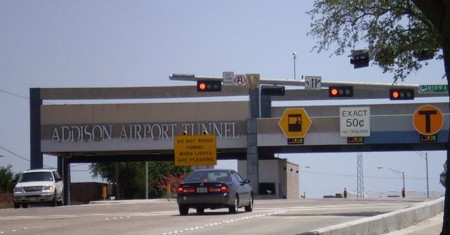 Gantry building with lanes labeled for full-service, exact change, and electronic tolling