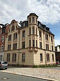 Apartment building in half-open development and in a corner location, with outbuildings