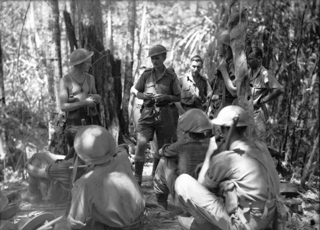 Lieutenant Colonel A.G. Cameron, commanding officer, delivering orders for a patrol around Menari, September 1942