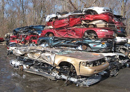 stacks of crushed cars in a scrapyard