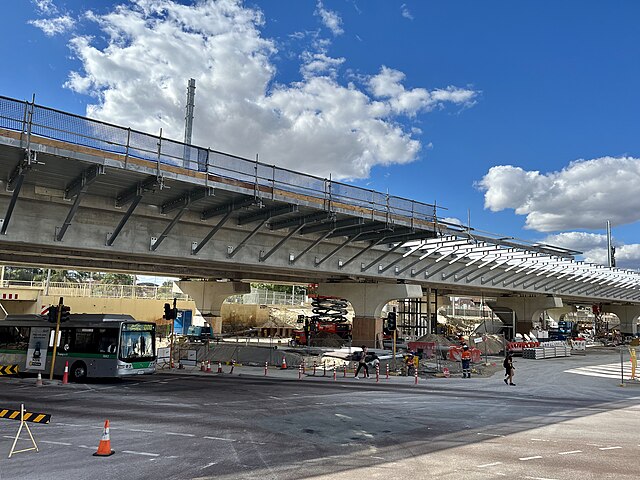 Concrete viaduct crossing street with construction site underneath