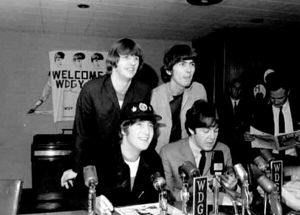 The Beatles at a press conference during their August 1965 North American tour, two months before the start of the Rubber Soul sessions