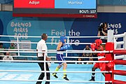 Deutsch: Boxen bei den Olympischen Jugendspielen 2018 Tag 12, 18. Oktober 2018 - Finale Fliegengewicht Mädchen – Martina La Piana (Italien, blau) schlägt Adijat Gbadamosi (Nigeria, rot) 5-0; Ringrichter ist James Beckles (Trinidad und Tobago). English: Boxing at the 2018 Summer Youth Olympics on 18 October 2018 – Girl's flyweight Gold Medal Bout - Martina La Piana (Italy, blue) beats Adijat Gbadamosi (Nigeria, red) 5-0; Referee is James Beckles (Trinidad and Tobago). Español: Boxeo en los Juegos Olímpicos Juveniles de Verano de 2018 en 18 de octubre de 2018 - Combate a medalla de oro de peso mosca para mujeres: Martina La Piana (Italia, azul) le gana a Adijat Gbadamosi (Nigeria, roja) 5-0; El árbitro es James Beckles (Trinidad y Tobago).