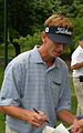 Brad Faxon signing autographs on the 17th green of the Congressional Country Club during the Earl Woods Memorial Pro-Am prior to the 2007 AT&T National tournament.