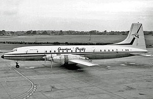 Black and white photo of plane in Canadian Pacific Air Lines livery parked at an airport